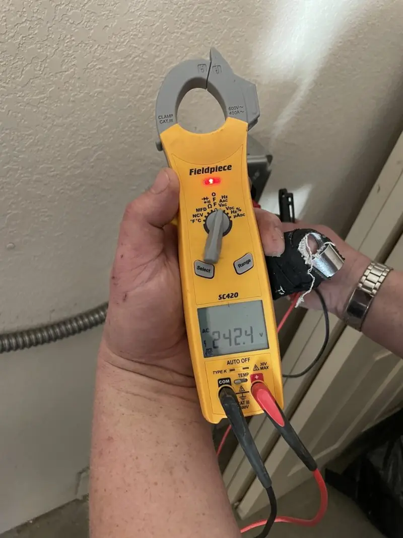 Voltage testing with clamp meter during Outlet Installation in Wellsville